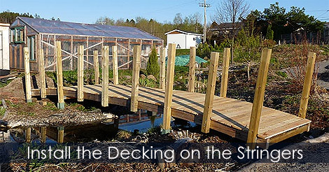 Laying deck boards on garden bridge stringers - Installing the slats - Pond bridge woodworking project 