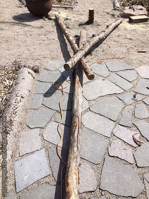 Build a tripod using string and three logs of wood