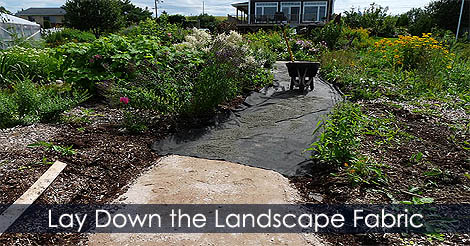 How to lay a gravel path - Lay down the landscape fabric over the compacted stone