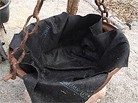 Lay down a landscape fabric to the bottom of the cauldron