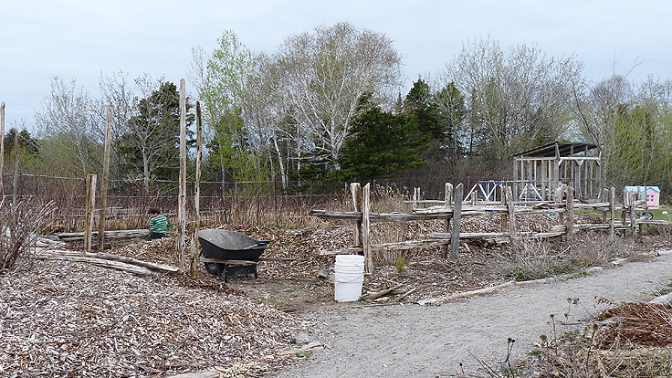 Installing a cedar split rail fence around a vegetable garden